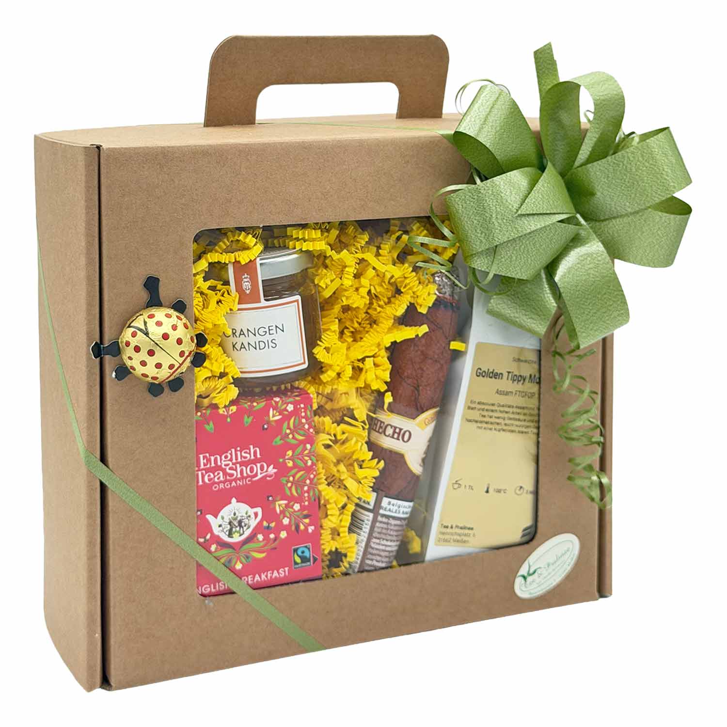 Geschenkbox mit English Tea Shop-Tee, Orangen Kandis, Schokoladenzigarre und Golden Tippy-Tee, verziert mit einer grünen Schleife.
